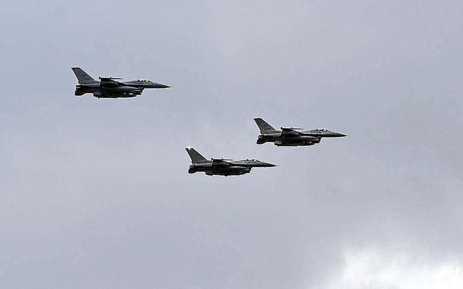A trio of F-16s from Spangdahlem Air Base, Germany, do a flyby over Ramstein Air Base following the memorial service for Airman 1st Class Zachary Cuddeback on Thursday. Cuddeback was one of two airmen killed by a gunman at Frankfurt airport last Wednesday.
