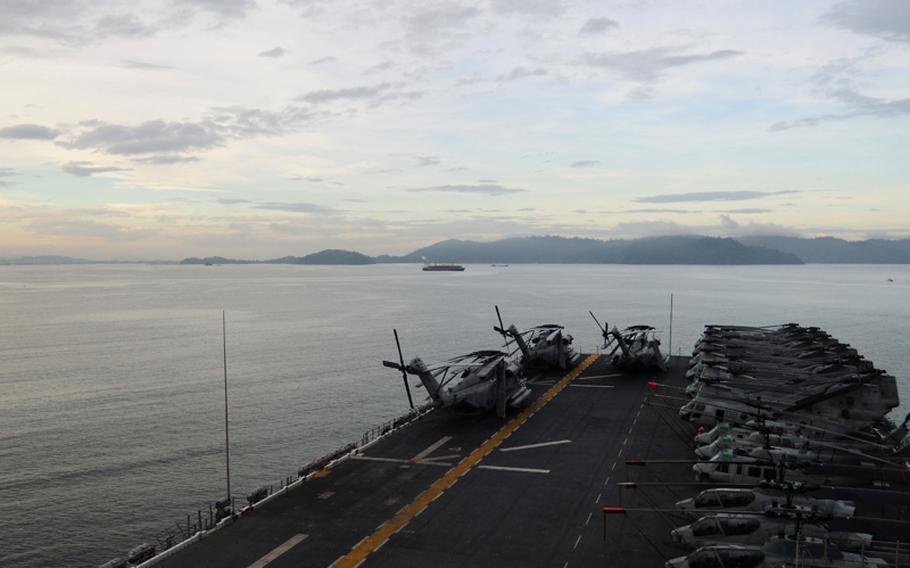 The forward-deployed amphibious assault ship USS Essex gets underway from Sepangar, Malaysia, to support earthquake and tsunami relief operations in Japan.