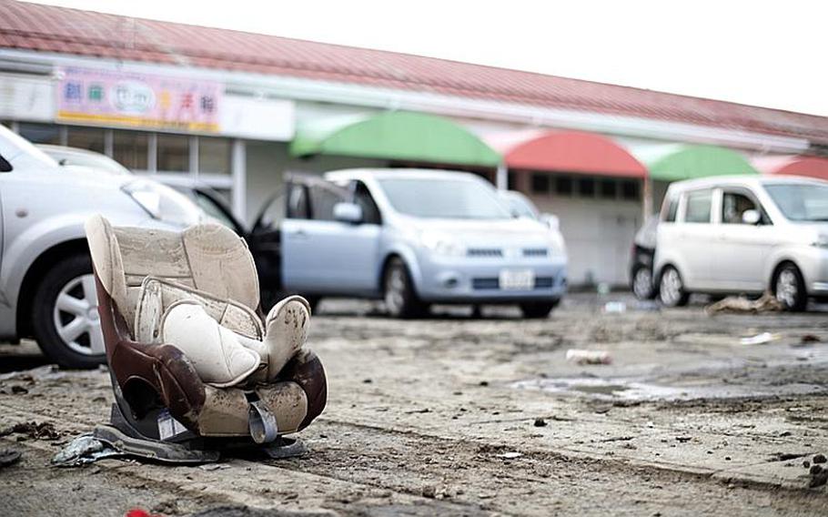 The streets of Tagajo, just east of Sendai, are riddled with debris and the battered remains of cars and trucks left behind by Friday´s earthquake.