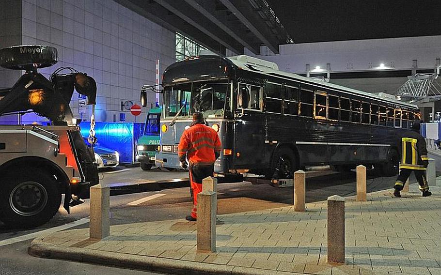 A blue U.S.Air Force bus is towed from Frankfurt airport's Terminal 2 after a shooting that killed two airmen on March 2.