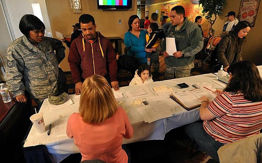 Community members on Saturday visit the first station of the pre-processing line at Misawa Air Base, Japan, for family members wishing to leave Japan under a voluntary departure program following a devastating earthquake and tsunamis that hit Japan on March 11.