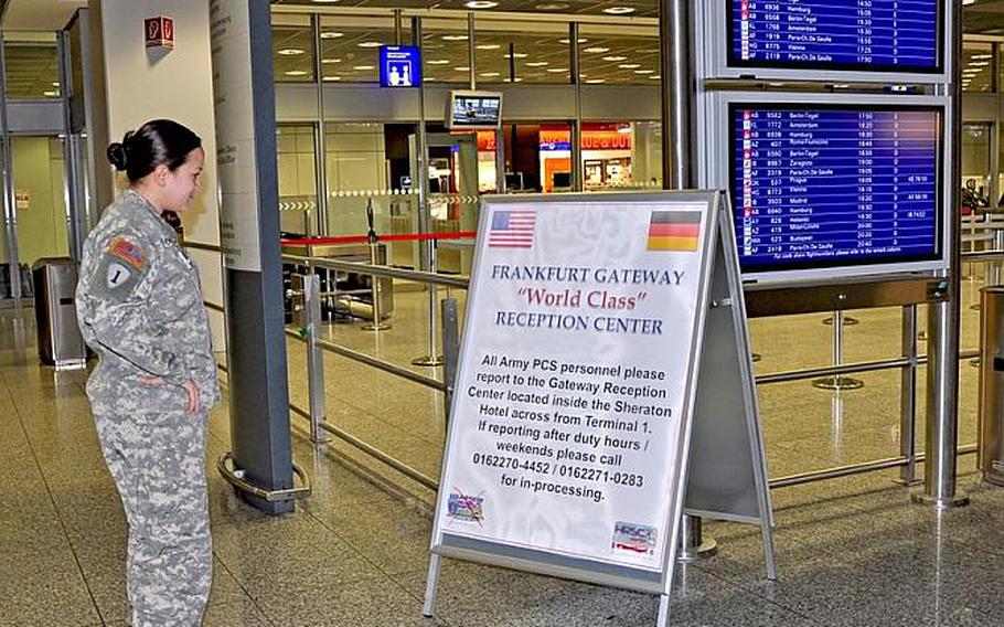 First Lt. Jacqueline Wood checks out one of the Frankfurt Gateway Reception Center signs welcoming newcomers at the Frankfurt Airport. Servicemembers in Europe have been banned from wearing uniforms off base in the wake of the March 2 shooting at the airport.