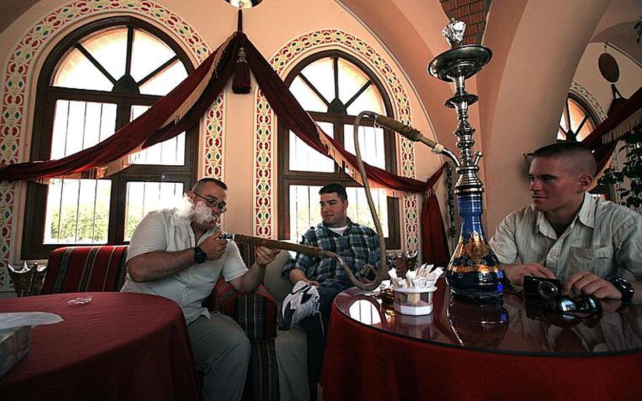 U.S. servicemembers visit a smoke house in Doha, Qatar, in 2007 while participating in the Camp As Sayliyah specialized rest and recuperation program.