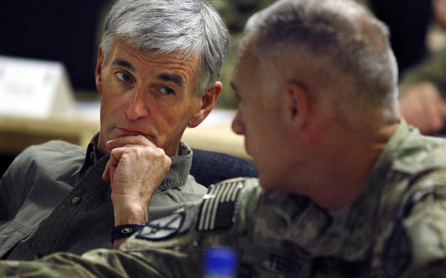Army Secretary John McHugh, left, speaks Thursday with ISAF Regional Command-South commander, Maj. Gen. James Terry while visiting Forward Operating Base Pasab.
