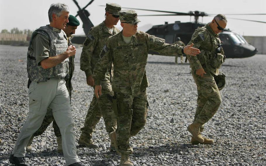 Army Secretary John McHugh, left, is escorted by Col. Patrick Frank, center right, as he arrives at Forward Operating Base Pasab in Afghanistan on Thursday. Also with him is Afghan Lt. Col. Abdul-Raheem, Sgt Maj. James Carabello, and ISAF Regional Command-South commander, Maj. Gen. James Terry, right.