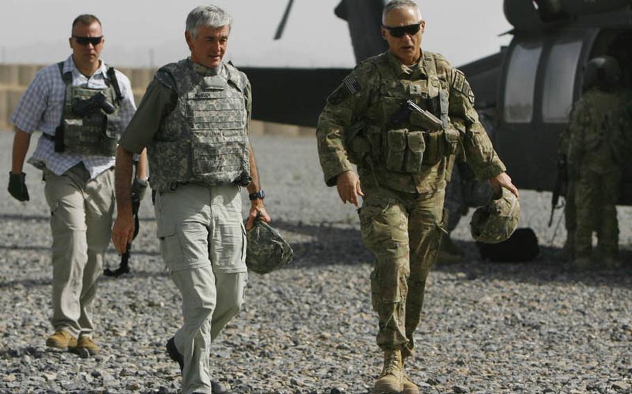 Army Secretary John McHugh, left, and Maj. Gen. James Terry, the ISAF Regional Command-South commander, arrive at Forward Operating Base Pasab in Afghanistan on Thursday.