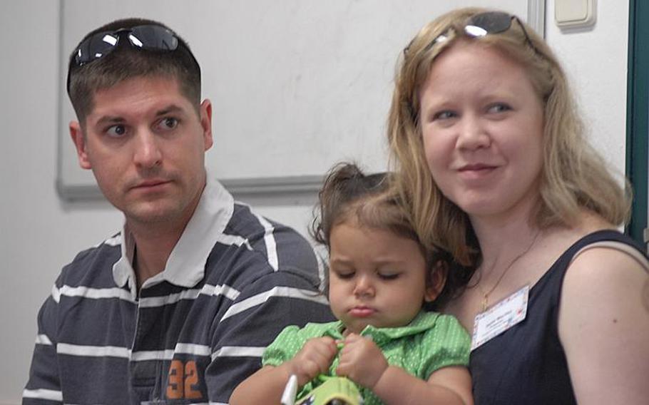 Air Force Staff Sgt. Eric MacVey and wife, Heidi, sit with their 18-month-old daughter, Abbi, during a seminar session at the 2011 European Adoption Symposium in Kaiserslautern, German, on Saturday.