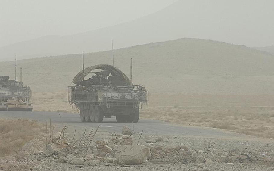 2nd Stryker Cavlary Regiment Stryker armored personnel carriers approach the site of a large IED (improvised explosive device) blast in Kanadahar Province, Afghanistan last summer.