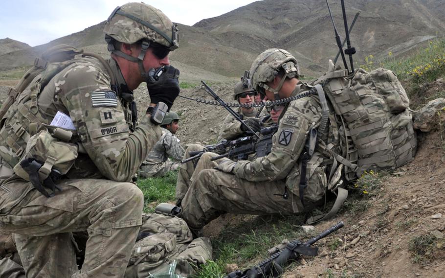 Capt. Josh O&#39;Dor, left, of the 2nd Battalion, 30th Infantry Regiment of the 10th Mountain Division, radios information to base commanders after his platoon took fire from insurgents during a patrol operation in southern Logar province last week. Two U.S. soldiers were wounded in the skirmish.