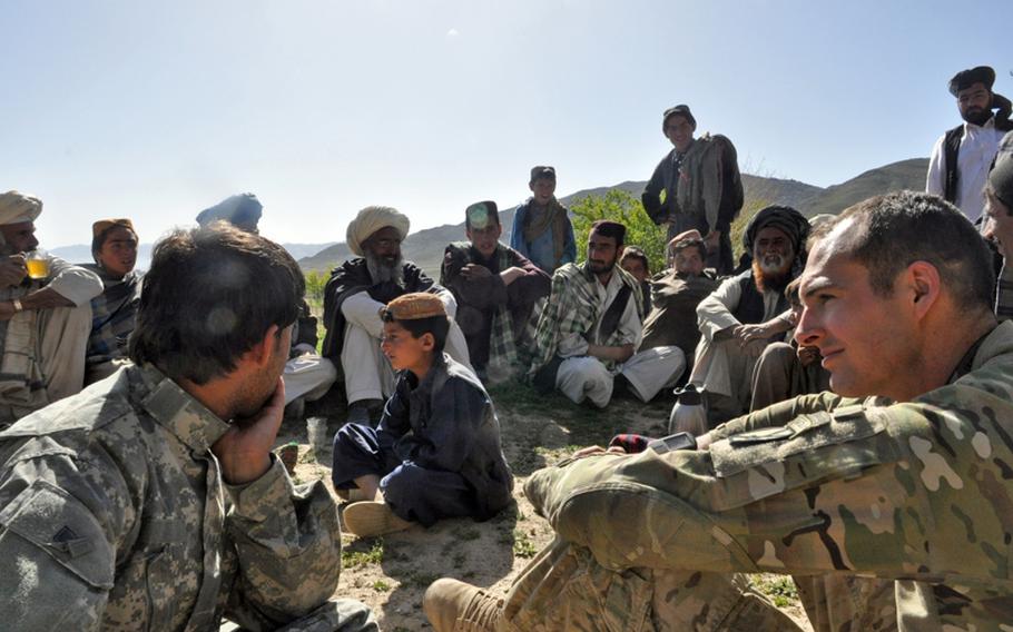 Capt. Josh O&#39;Dor, right, of the 2nd Battalion, 30th Infantry Regiment of the 10th Mountain Division listens to tribal elders during an informal shura last week in the village of Kor Jalal, located in southern Logar province.