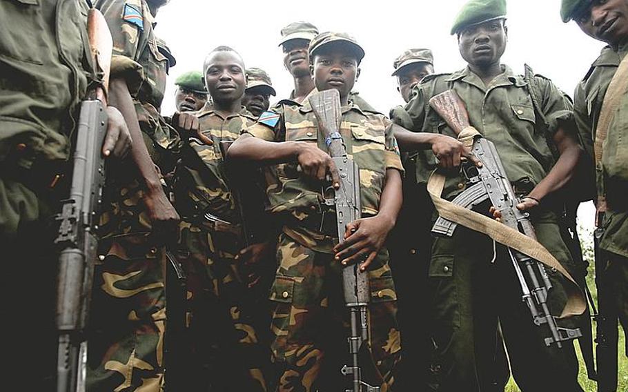 Pvt. Kasereka-Kasivire Heritier, center, a 21-year-old soldier with the Congolese army has been trained along with 750 other soldiers by Americans for the past year. Like many of his peers, Heritier&#39;s fighting life began long before he joined the army, serving with militia groups in the strife-stricken eastern part of the Democratic Republic of the Congo. Now, this newly trained battalion of soldiers is slated to deploy to a hot spot to take on a rebel group. The question now is whether the roughly $20 million spent by the U.S. to train the battalion will pay dividends.
