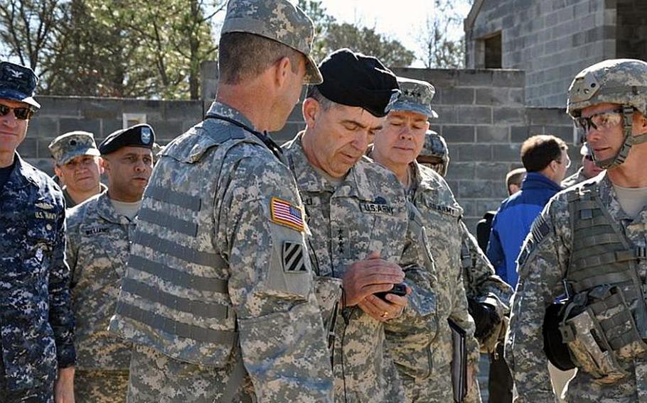 Gen. Peter Chiarelli, the Army&#39;s vice chief of staff, views a photo downloaded on a prototype JBC-P handheld smartphone. The Army is considering several options, including smartphones, for its battlefield networking system.