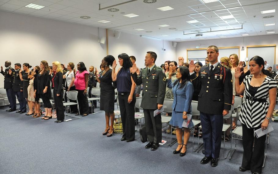 Thirty-seven new American citizens take the oath of Allegiance at a ceremony at the U.S. consulate in Frankfurt, on Wednesday.