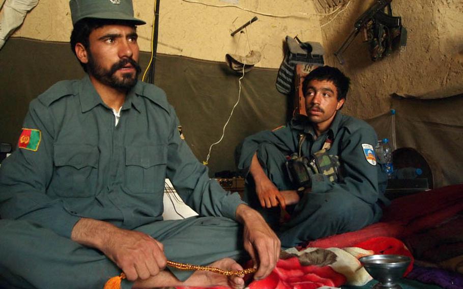 Nooroz Waly, left, who commands 30 police in northern Musa Qala district in Helmand province, has taken the initiative in trying to round up Taliban threatening his village.