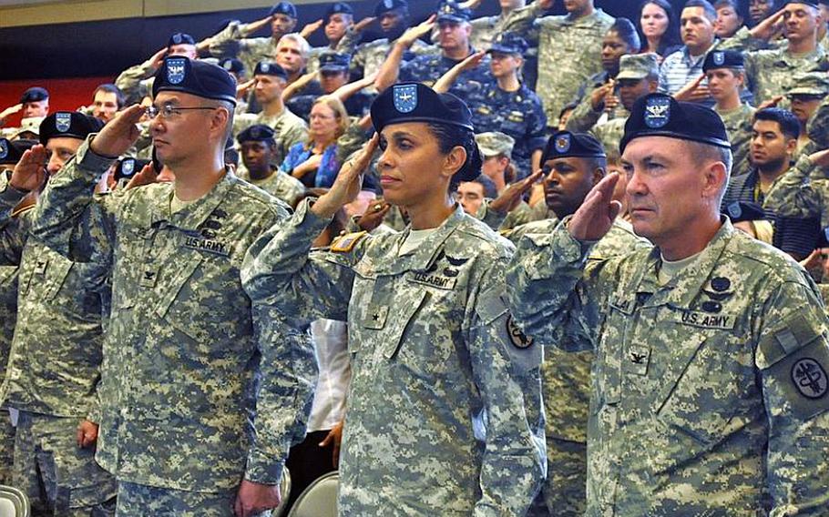 Army Col. John M. Cho, left, Army Brig. Gen. Nadja Y. West, center, and Army Col. Jeff B. Clark, right, salute during the playing of "The Star Spangled Banner." After the national anthem, all three took part in a change of command ceremony, in which Cho handed command of Landstuhl Regional Medical Center to Clark.
Seth Robbins/Stars and Stripes