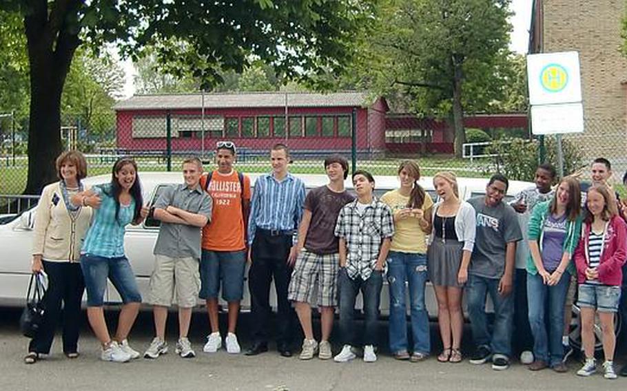Susan Krummrei stands in front of a limousine with 18 students from her final class before the group gets ready to depart Wiesbaden High School en route to lunch at Vapiano in downtown Wiesbaden.