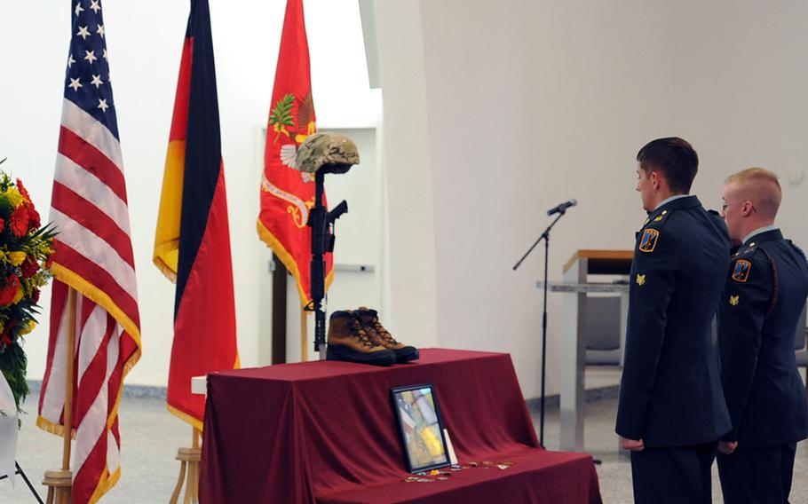 Soldiers give a final salute at the memorial ceremony held for Capt. Michael Newton at the Smith Barracks chapel in Baumholder, Germany, on Wednesday. Newton, of the 1st Battalion, 84th Field Artillery Regiment, 170th Brigade Combat Team, died in Afghanistan on June 11.