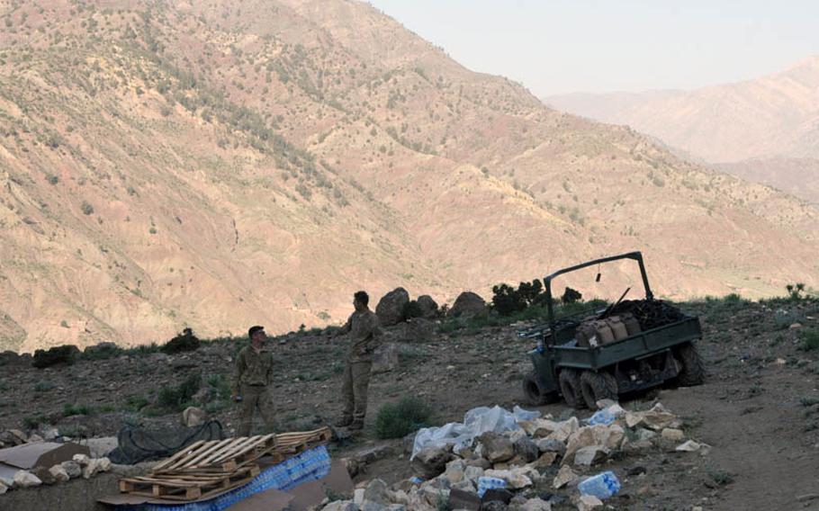 First Lt. Roderic O'Connor, left, and Sgt. Aaron Welch stand near a Gator that would cause its share of problems during their platoon's mission to the Azra district of Logar province in mid-June.
