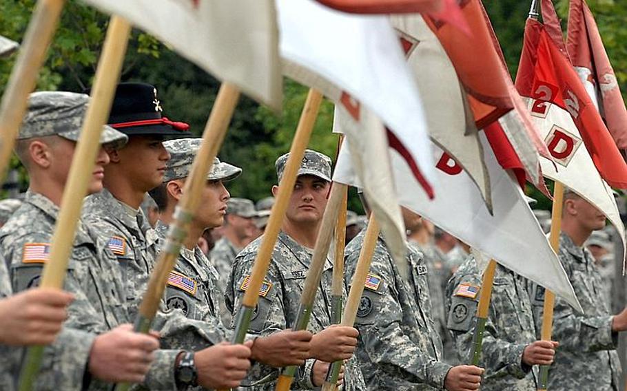 Spc. Timothy Perez, 2nd Stryker Cavalry Regiment, stands with soldiers during Friday's uncasing of colors and memorial ceremony. Twenty soldiers were killed during the regiment?s deployment to Afghanistan, between June 2010 and May.
Steven Beardslsey/Stars and Stripes