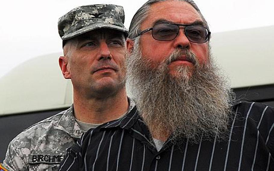Steve House, center, points to an area at Camp Carroll&#39;s helipad, where he claims he buried barrels of Agent Orange in 1978. Behind him is is Col. Joseph Birchmeier, a U.S. Forces Korea engineer.