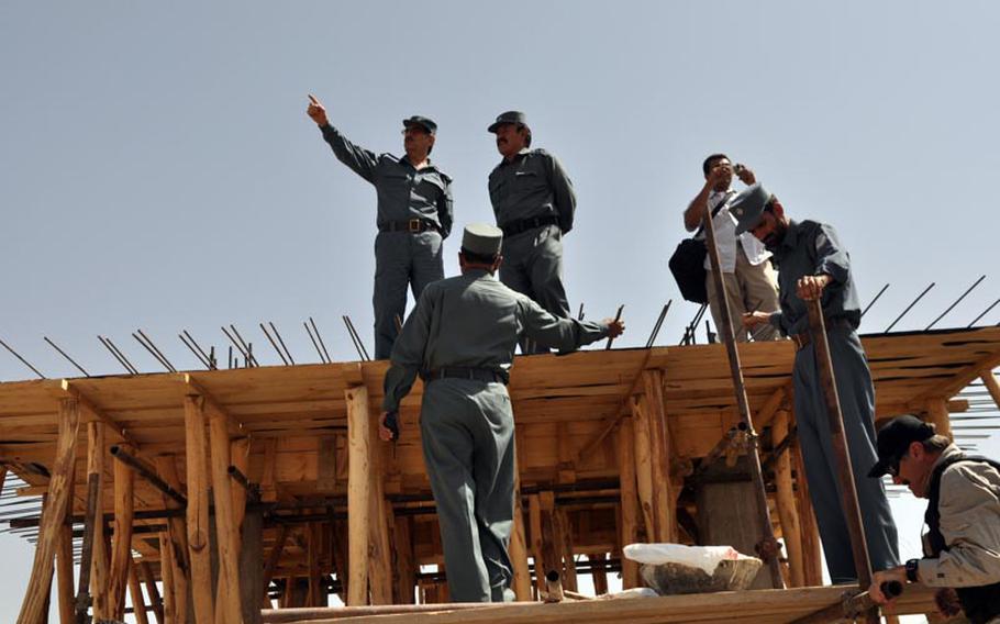 Gen. Amir Jamshid (pointing) inspects the construction site of a new prison in Maidan Shar, capital of Wardak province. Jamshid is head of Afghanistan's Central Prison Directorate.