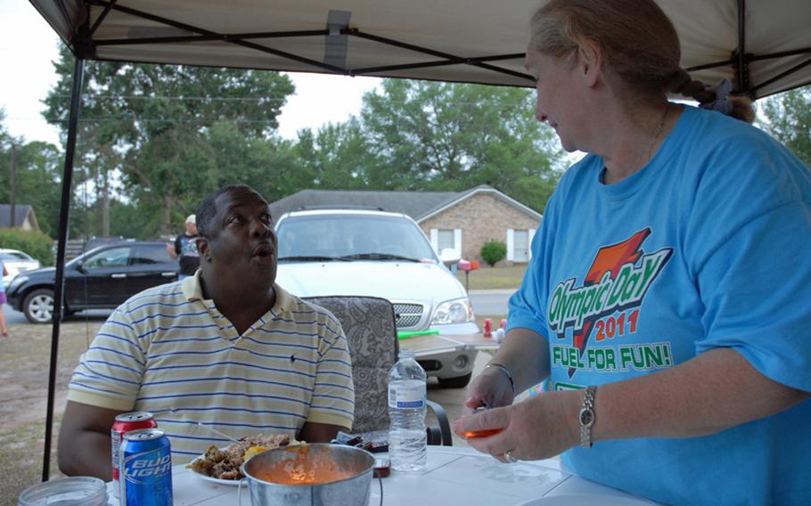 Maj. Shabon Shelton and Janet Gladwell talk at a barbeque at Gladwell&#39;s house by Fort Stewart, Ga. The two have formed an unlikely friendship. Gladwell&#39;s son, former Army Sgt. Robert Quinones, held Shelton hostage last September at Fort Stewart&#39;s hospital. Shelton is trying to help Quinones get treatment for his Post Traumatic Stress Disorder.