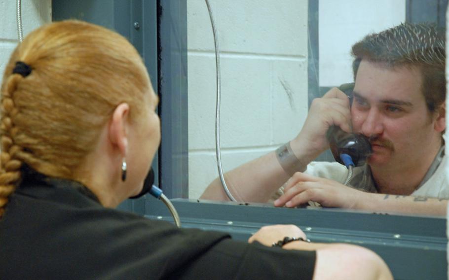 Former Army Sgt. Robert Quinones talks to his mom, Janet Gladwell, during weekly visiting hours at a county jail in Statesboro, Ga. Quinones is being held for going into the hospital on nearby Fort Stewart and holding three soldiers hostage in September 2010.