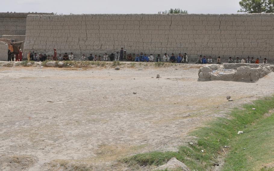 Afghan boys gathered one morning last week to watch U.S. soldiers from the Third Brigade Combat Team of the 25th Infantry Division extract an IED from a dirt road in Rodat, a village in eastern Nangarhar province.