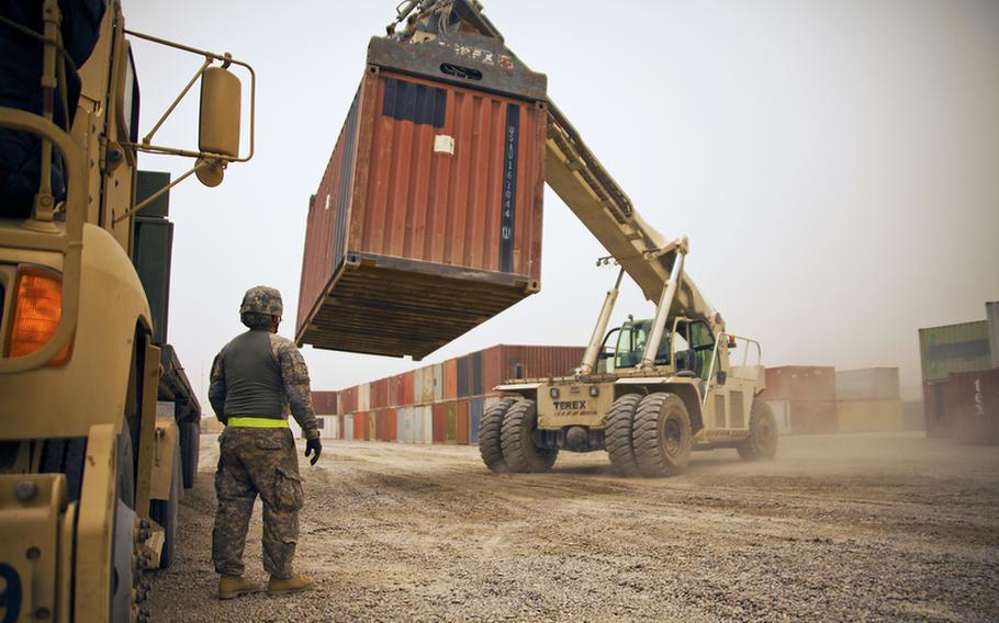 Pfc. Jesus Valladares, from the 68th Transportation Company, 142nd Combat Sustainment Support Battalion oversees the loading of a cargo truck at the U.S. Army&#39;s largest Central Receiving and Shipping Point yard at Sather Air Base outside Baghdad. The containers are full of goods that have arrived from closing bases throughout Iraq and are headed to Contingency Operating Base Adder, an enduring U.S. base in Tallil, Iraq.