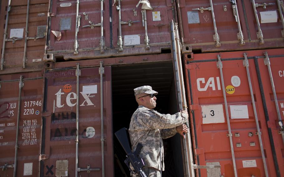 Sgt. 1st Class William Rivera Jr., a supply sergeant at Forward Operating Base Union III in Baghdad's International Zone, inspects containers full of supplies that are to be repurposed as part of the U.S. drawdown in Iraq.
