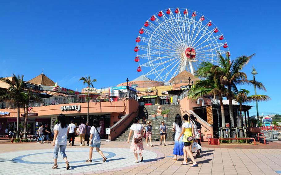 Shoppers stroll through American Village, a plot of former U.S. Army land that has been redeveloped into an entertainment and shopping complex that attracts about 1 million visitors each year. Okinawa is hoping to have similar redevelopment success as other military properties are returned following a realignment of U.S. forces that will close Marine Corps bases south of Kadena Air Base.