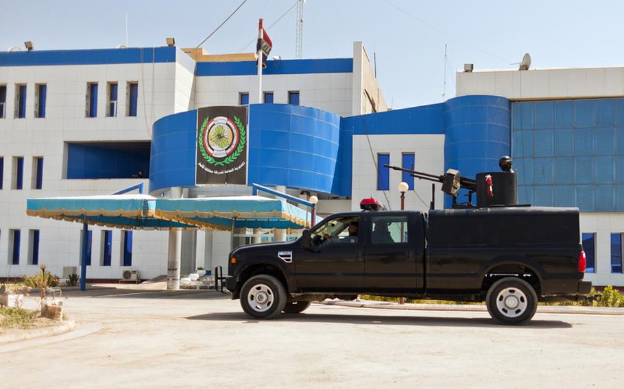 An armed Iraqi police vehicle enters the Police Headquarters in Ramadi, Iraq on Aug. 13.