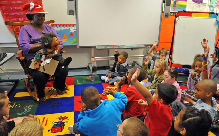 Pupils at Mannheim Elementary School raise their hands to get the chance to answer a question in Maxie Egele&#39;s second grade class, on the first day of school Monday. It is the final year for the elementary school, as the Mannheim military community closes down.