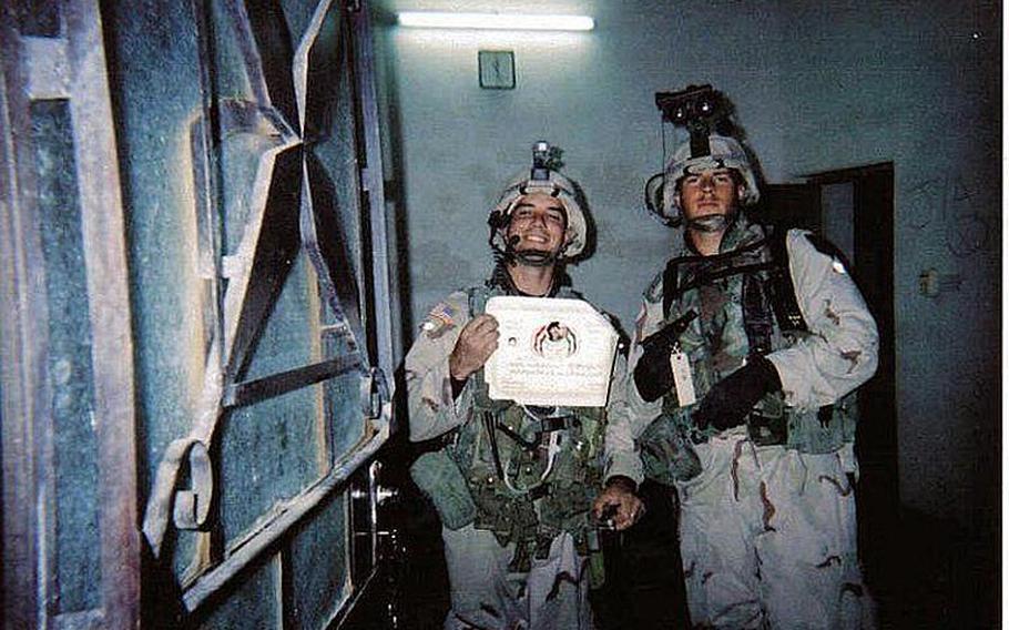 Jamey Raines, then an Army sergeant, and his fellow soldier, Shane Rawson, then a specialist, hold a certificate and pistol they seized after capturing a former general who had served in Saddam's army in 2004. Raines says using marijuana helped him to keep his post-traumatic stress disorder under control while he attended college on the GI Bill.