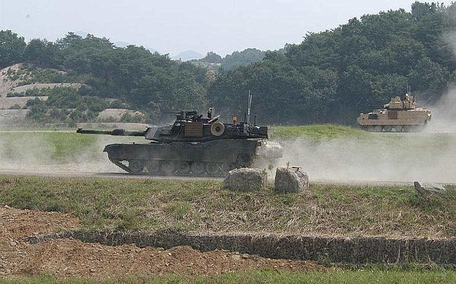 The U.S. and South Korean militaries staged an exercise Sept. 1, 2011, about 15 miles from the Demilitarized Zone, the star attractions of which were examples of the dozens of new M1A2 SEP Abrams Main Battle Tanks, left, and M2A3 Bradley Fighting Vehicles, right, that have been brought to South Korea in recent months.