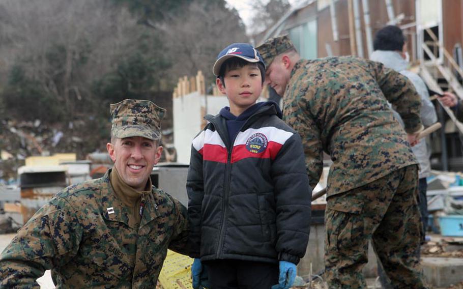 Marine Capt. Caleb Eames, from Okinawa's 31st Marine Expeditionary Unit, was reminded of his work at Ground Zero when he saw Ikuta Yataru, 8, digging through the dirt on Oshima Island after a tsunami hit Japan.
