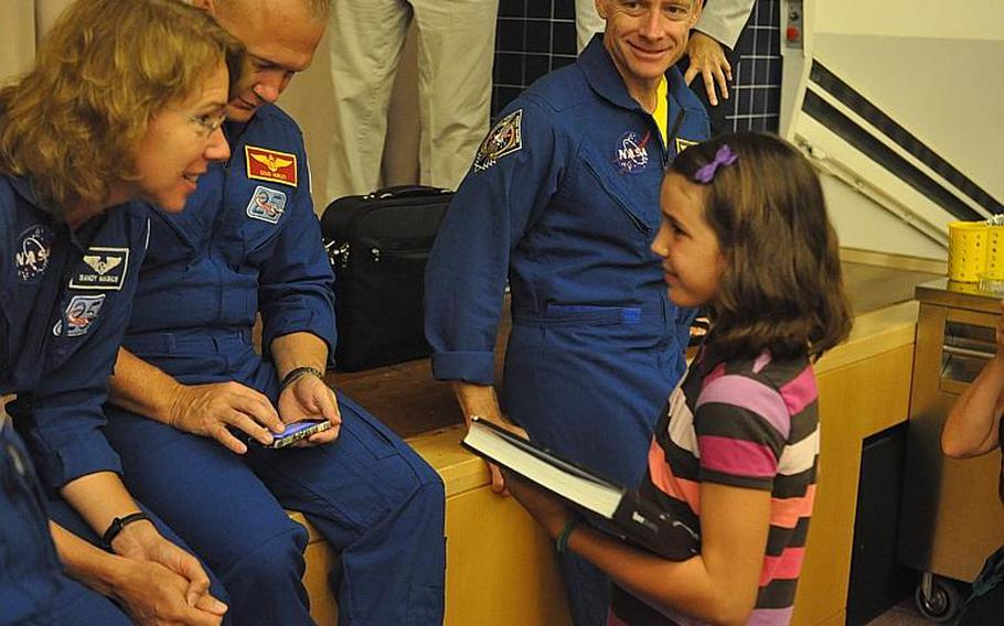 Space Shuttle Atlantis crewmember Sandy Magnus talks with Julia Gabel, a fifth-grader at Aviano Elementary School during the four-member crew's visit to Aviano Air Base on Friday. The astronauts are heading back to the States after visiting U.S. bases in Italy and Turkey the past two weeks.