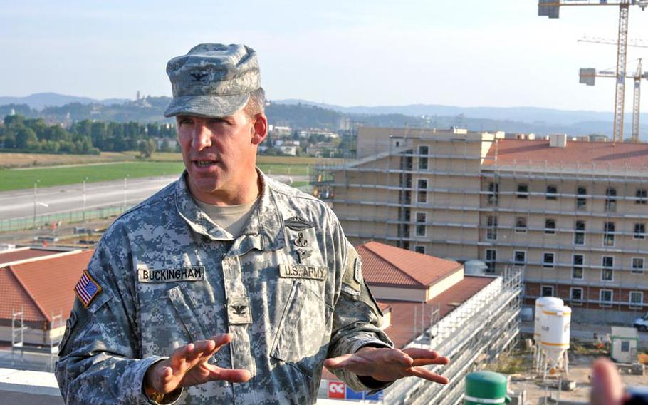 Col. David Buckingham, commander of U.S. Army Garrison-Vicenza, makes a point during a tour of the Dal Molin aifield for Italian civic leaders on Thursday. Behind him to the right is one of the barracks buildings under construction that about 1,200 soldiers will call home when the $289 million project is completed. That's projected to happen in phases in 2013 and 2014.