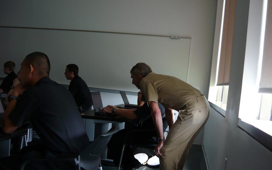 Simon helps a first-year midshipman practicing basic website-attack techniques during a class last month at the U.S. Naval Academy in Annapolis, Md. This is the first year midshipmen have been required to take a cyber class.