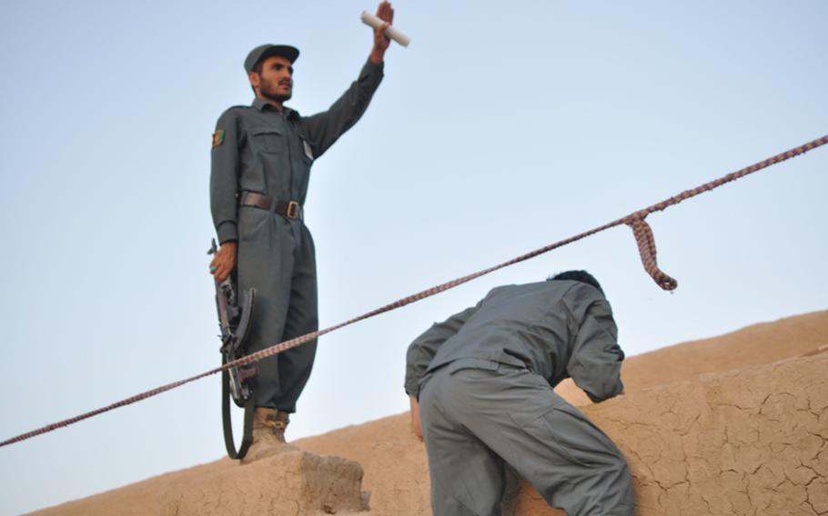 Afghan policemen climb to rooftop positions during a joint raid with American troops in Kandahar City in September. ''They're getting there,'' an American officer said. ''But they're not there yet.''
