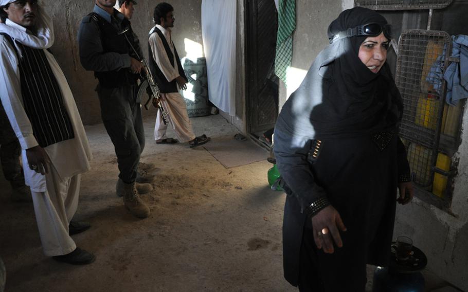 An Afghan policewoman gives orders during the search of a compound in northwestern Kandahar City this September.