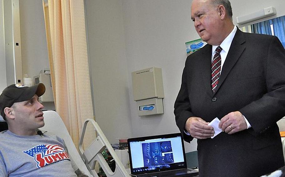 Undersecretary of the Army Joseph Westphal visits Sgt. Chad Hall at Landstuhl Regional Medical Center in Germany. Hall, with the 1st Battalion, 503rd Infantry Regiment, 173 Airborne Brigade Combat Team, had surgery on several of his vertebrae and was recuperating the morning of Nov. 22, 2011.