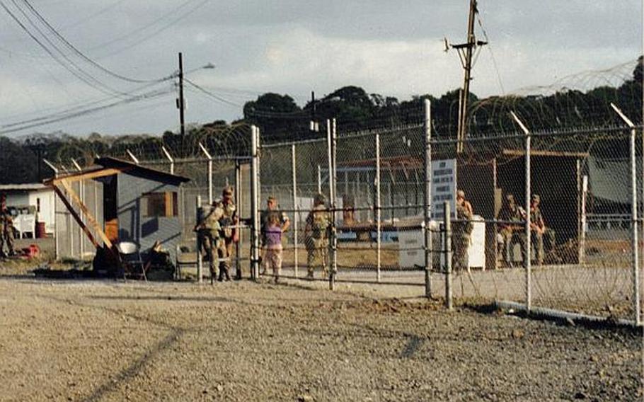 Soldiers gather at the gate of one of the four camps that the U.S. military built to house Cuban refugees in Panama in 1994. On Dec. 8, 1994, hundreds of refugees rioted, throwing thousands of rocks at U.S. soldiers who came inside to quell the disturbance.