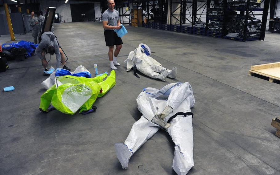 Staff Sgt. Tim Butler, right, and Sgt. David Larkin, both of the 773rd Civil Support Team clean their HAZMAT suits following a training exercise in Kaiserslautern on Dec. 6. The 773rd CST is the only active Army Reserve Civil Support Team stationed outside of the continental U.S., and is capable of deploying in support of U.S. Army Europe in response to a chemical, biological, radiological or nuclear incident.