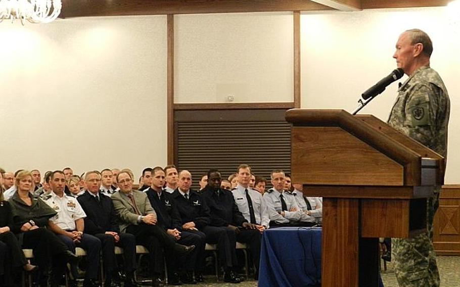 Gen. Martin Dempsey, chairman of the Joint Chiefs of Staff, speaks to servicemembers and civilians during a town hall meeting Dec. 19, 2011, at Ramstein Air Base, Germany. Dempsey touched upon several topics, including education benefits and retirement.