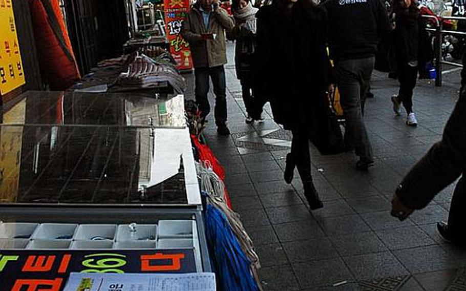 South Koreans go about their daily business Dec. 20, 2011, a day after news broke that North Korean leader Kim Jong Il was dead. Life appeared to go on as normal for most residents of the South, despite international fears that North Korean internal problems could lead to problems for South Korea.