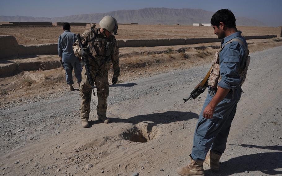 A German officer and a member of the Afghan National Police inspect a hole in which German troops, acting on a tip, found an improvised explosive device in the Char Dara district of Kunduz province in October. IED attacks against NATO troops have been rising in northern Afghanistan over the last several years -- but German troops say they are now more likely to find the bombs before they explode. "We steal them from the insurgents," Master Sgt. Andreas Kaitschik said. "We make it expensive for them. It feels good. You can see it."