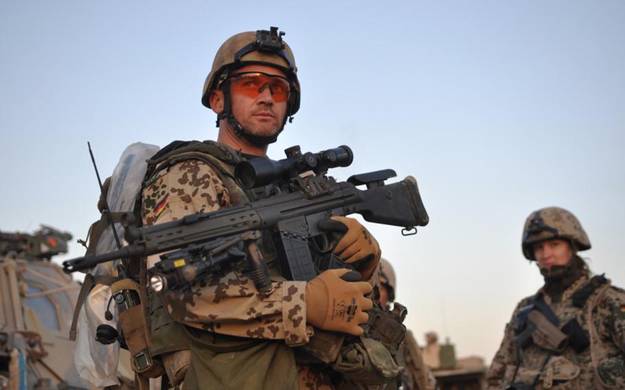 A soldier nicknamed "Gizmo," from Germany's Platoon B, 2nd Infantry Company, Task Force Kunduz, Afghanistan, prepares for a mission shortly after dawn.