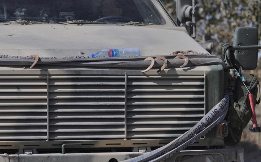 Horseshoes dug out of the road by explosive ordnance disposal teams adorn the hood of a German truck during a patrol along Route Cherry in Afghanistan's Kunduz province, site of several bomb attacks. "Our intelligence tells us this is the most dangerous road in the area," an officer said. "All we find is horseshoes."