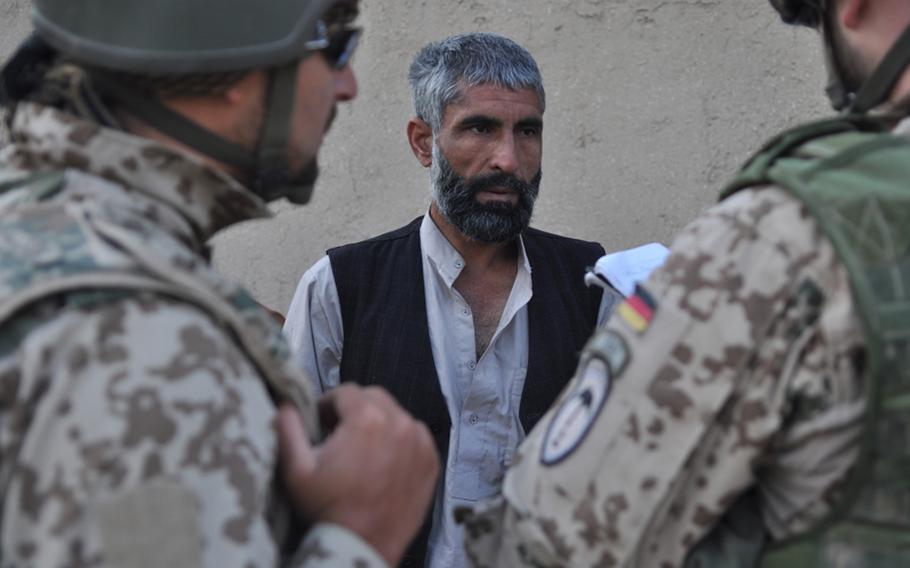 German soldiers question an Afghan during a dawn raid in the Char Dara district, Kunduz province. The soldiers were searching for a Taliban bomb-maker, but they did not find him. While the Kunduz region was relatively quiet during the early years of the war, it has become increasingly violent.